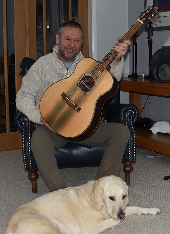 simon onions guitar craftsman with his dog